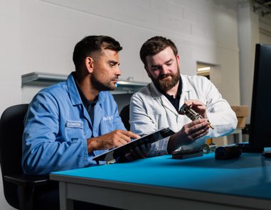 Ed Compton and Andy Palmer inspecting rate of climb indicator staged customer embedding for transition knowledge transfer
