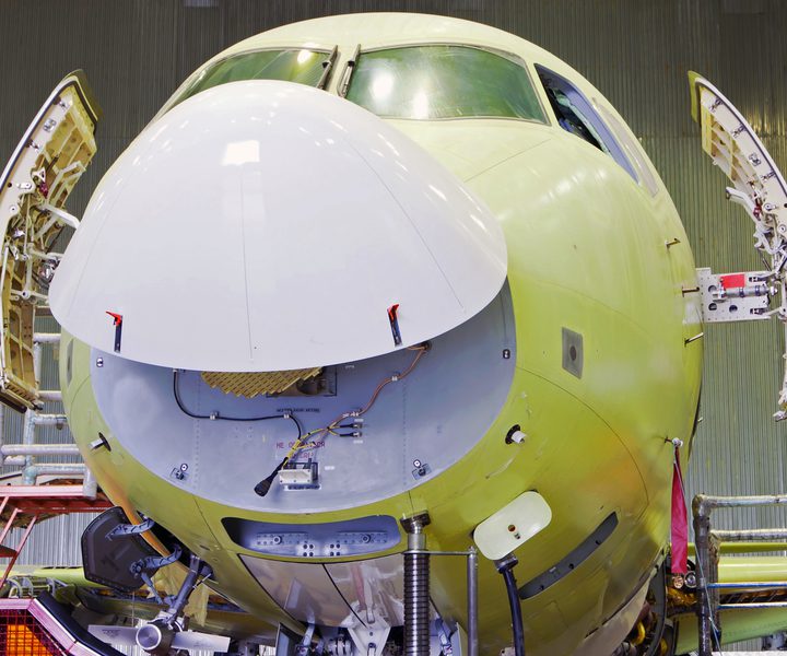 Passenger aircraft with a raised fairing. The plane seems to be smiling. Front view of a airplane.