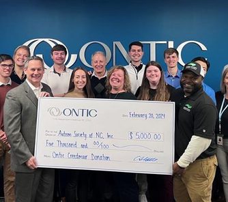 Ontic presents cheque to Autism Society