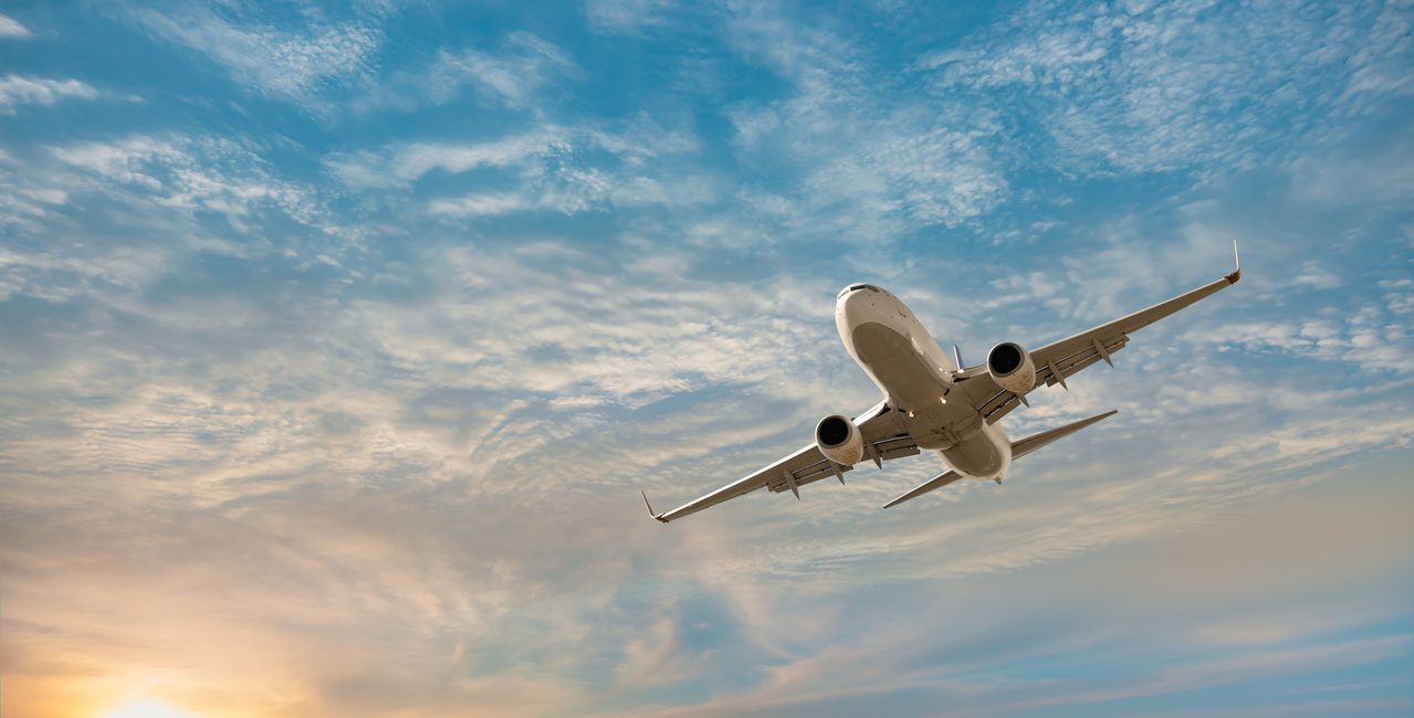Airplane flying over tropical sea at sunset - Antalya, Turkey