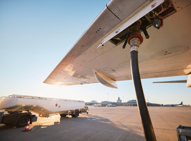 Refueling of airplane at airport. Ground service before flight.