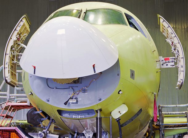 Passenger aircraft with a raised fairing. The plane seems to be smiling. Front view of a airplane.